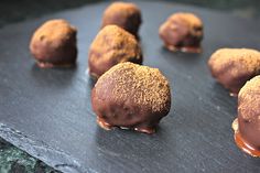 chocolate covered donuts sitting on top of a counter