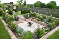 an outdoor garden with stone steps and flowers in the center, surrounded by greenery