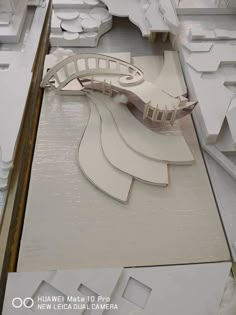 an architectural model of a bridge in the middle of a room with white walls and flooring