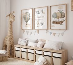 a room with some pictures hanging on the wall and stuffed giraffe in the corner