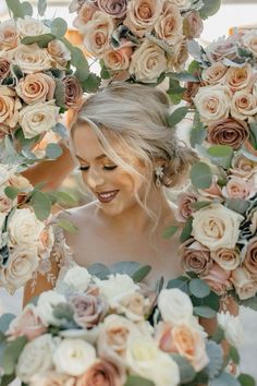 a woman holding a bouquet of flowers in front of her face