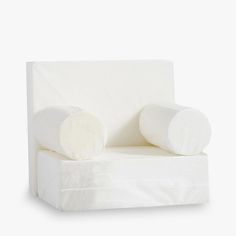 a white chair with two pillows on it's back and one arm in the shape of a reclining couch