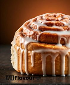 a bundt cake covered in icing on top of a wooden table