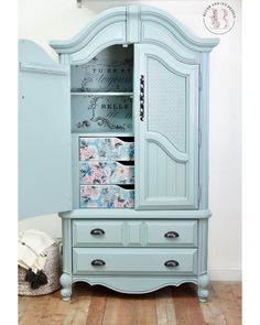 a blue armoire with drawers on top of it