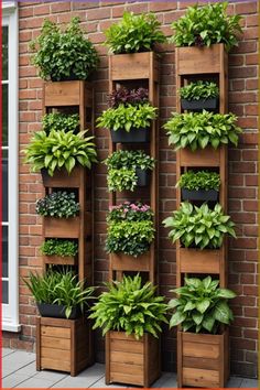 a tall wooden planter filled with lots of green plants next to a brick wall