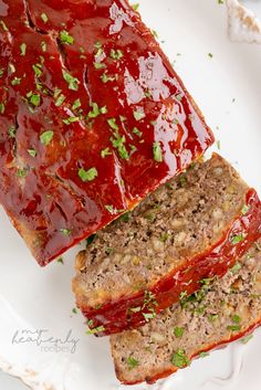 two slices of meatloaf on a plate with ketchup and parsley