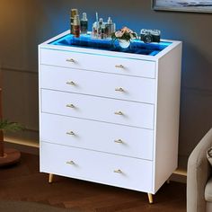 a white chest of drawers with drinks on top