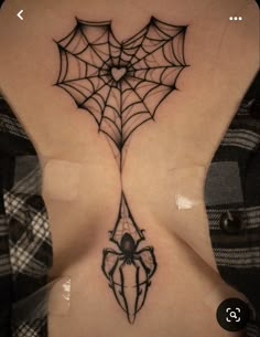 a woman with a spider tattoo on her back