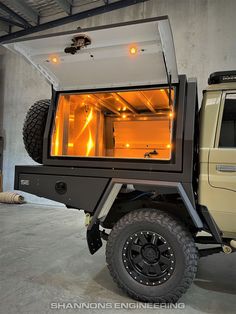 an off - road vehicle with its doors open and lights on