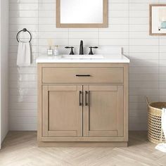 a bathroom vanity with a mirror above it next to a white tiled wall and floor