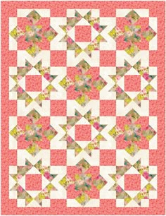 a pink and yellow quilt with many different designs on it's sides, including the center