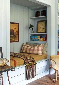 a room with some bookshelves and pictures on the wall