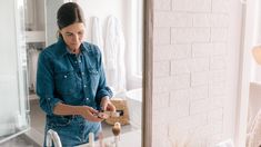 a woman standing in front of a bathroom sink