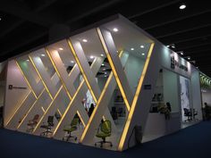 an exhibition stand with chairs and lights on it