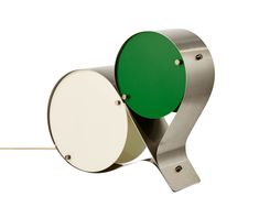 a green and white lamp sitting on top of a metal stand