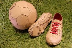 a pair of shoes and a soccer ball on the ground