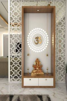 a room with a white wall and gold decorations on the walls, along with a buddha statue