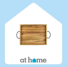 a wooden cutting board sitting on top of a blue and white background with the words at home above it