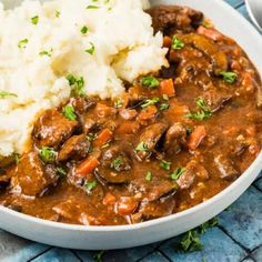 a white bowl filled with meat and mashed potatoes