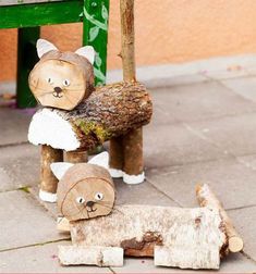 two wood cut animals sitting on top of a wooden bench