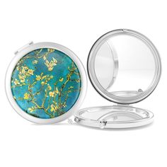 a compact mirror with a blue and yellow flower design on the front, open to show it's reflection