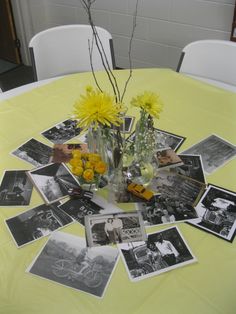 a table topped with pictures and vases filled with flowers on top of a yellow table cloth