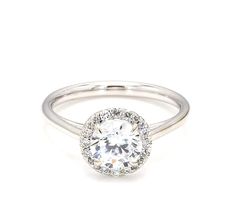 a white gold engagement ring with an oval diamond center and pave - set shoulders