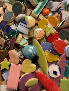 a pile of different colored glass and metal items on top of each other in various shapes and sizes