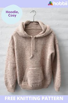 a sweater hanging on a hook with the text hoodie, cozy free knitting pattern