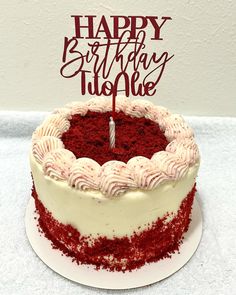 a red velvet birthday cake with white frosting