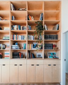 a bookshelf filled with lots of books next to a doorway