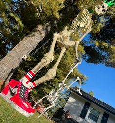 a fake skeleton is in the grass next to a house