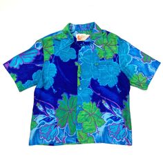 Vintage Liberty House Hawaiian Shirt - 1970's - Men's Medium to Large - check sizing measurements below  Condition:  Very Good Vintage Condition - fabric is soft and shows a little wear from normal wash and wear - the smaller care tag is frayed and a bit harder to read - there is a fabric look so there was most likely a button underneath the collar at the top of the neck, and if so, it is missing - preowned The shirt has the original tags.  It also has the original fabric covered buttons down the front, as well as a small front pocket on the left chest area. Due to the softness of the fabric, pocket is slightly stretched. DIMENSIONS -  measured flat -- Tag reads Large, vintage sizing may be slightly smaller - check measurements below to ensure a good fit. Width armpit to armpit: 21 inches Multicolor Camp Shirt With Hibiscus Print And Camp Collar, Vintage Short Sleeve Camp Shirt With Hibiscus Print, Vintage Short Sleeve Shirt With Hibiscus Print, Retro Blue Floral Print Tops, Blue Collared Shirt With Retro Print, Hawaiian Short Sleeve Shirt With Retro Print, Retro Blue Collared Hawaiian Shirt, Hawaiian Style Short Sleeve Shirt With Retro Print, Blue Hawaiian Camp Shirt With Hibiscus Print