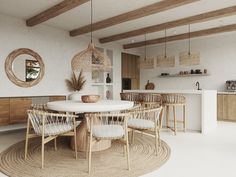 a white table and chairs in a room with wood beams on the ceiling above it