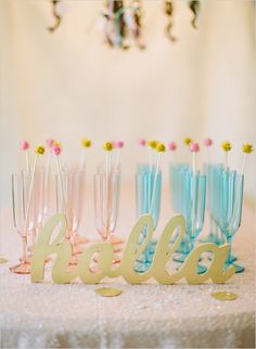 a table topped with lots of glasses filled with champagne