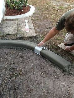 a man bending over to put something in the ground