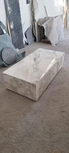 a marble coffee table sitting on top of a carpeted floor