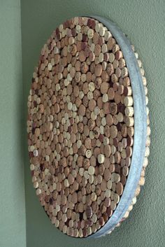 a round object made out of wine corks on a wall