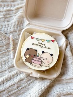 there is a cake in the box with two bears on it