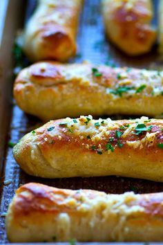 breadsticks are lined up on a baking sheet and ready to be baked in the oven