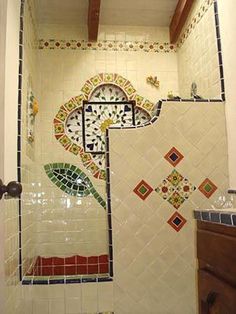 a bathroom with white and green tiles on the wall