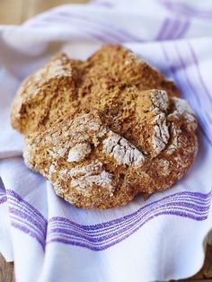 two cookies sitting on top of a purple and white towel