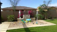 a backyard with a water fountain and children's play area