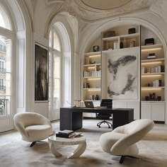 an elegant office with two chairs and a desk