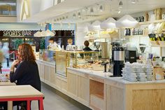 a woman sitting at a table in front of a counter