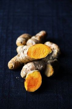 some very pretty yellow and brown vegetables on a blue surface