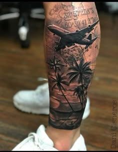 a man's leg with an airplane and palm trees on it