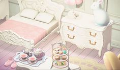 a room with a bed, dresser and table filled with teacups on it