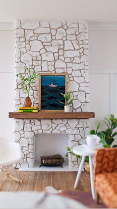 a living room filled with furniture and a fire place next to a wall mounted painting