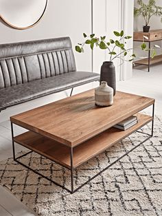 a living room scene with focus on the coffee table and sofa in the foreground